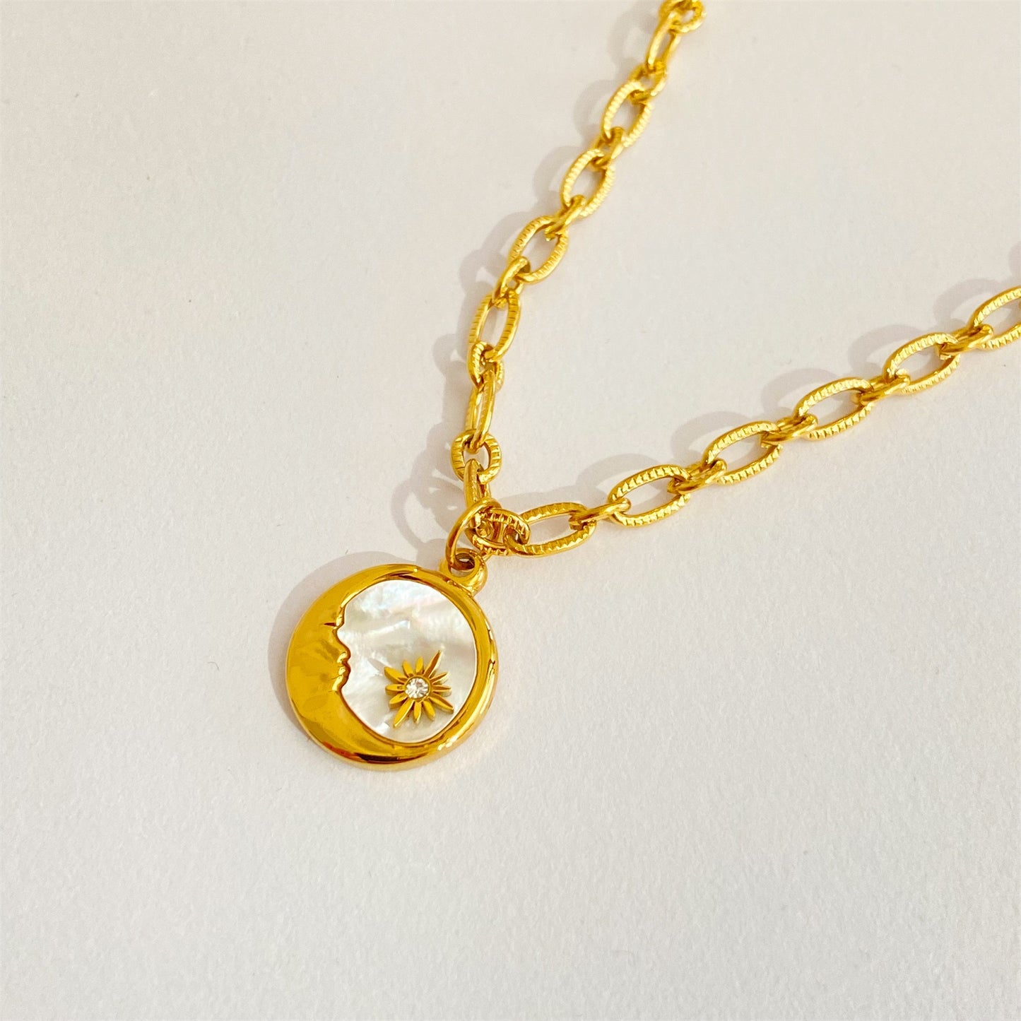 Retro 3D Sun Moon Round Coin Necklace with Mother-of-Pearl Pendant
Titanium Steel Electroplated with Real Gold whimsical
